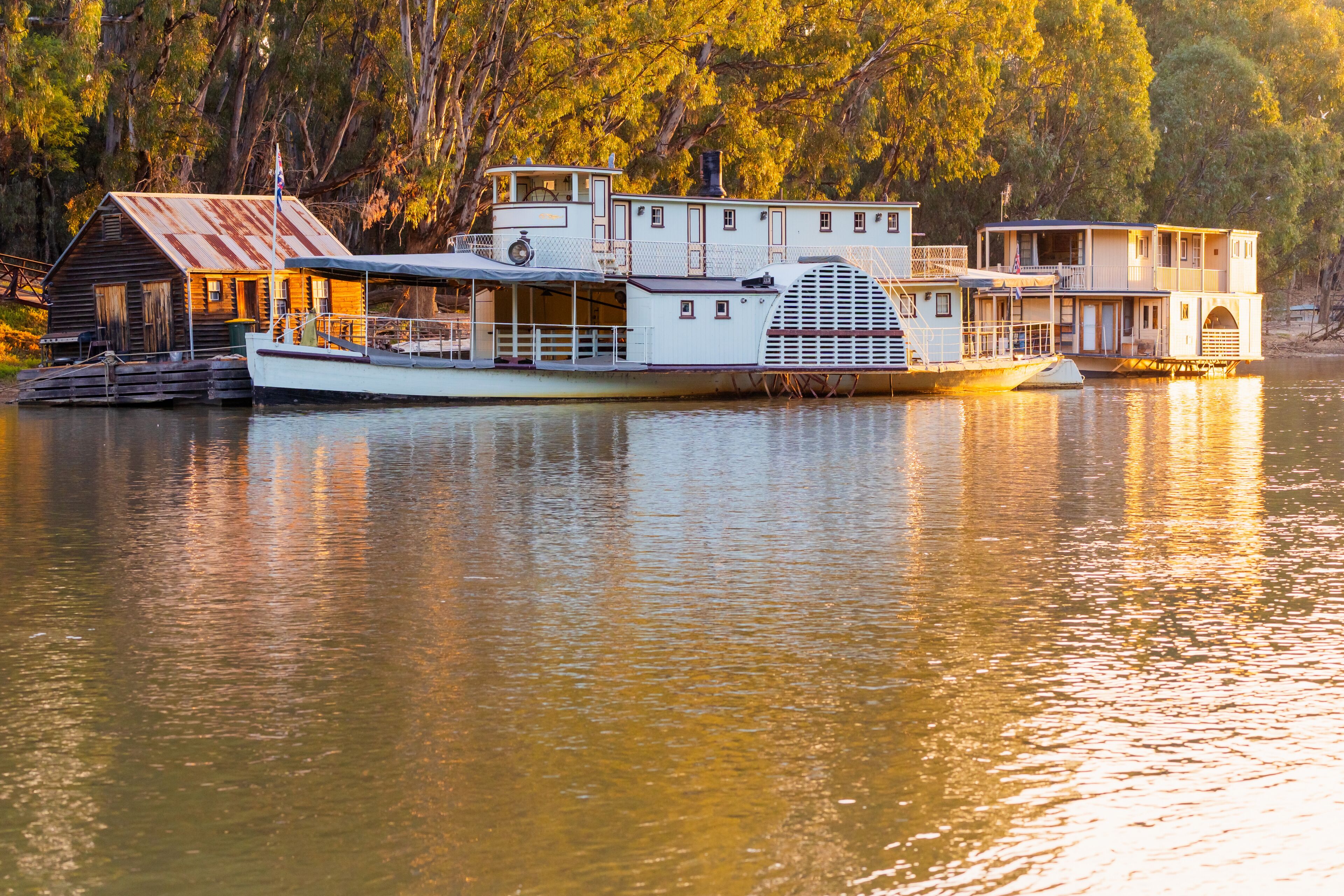 Golden sunset lighting and reflection on an historic paddle steamer