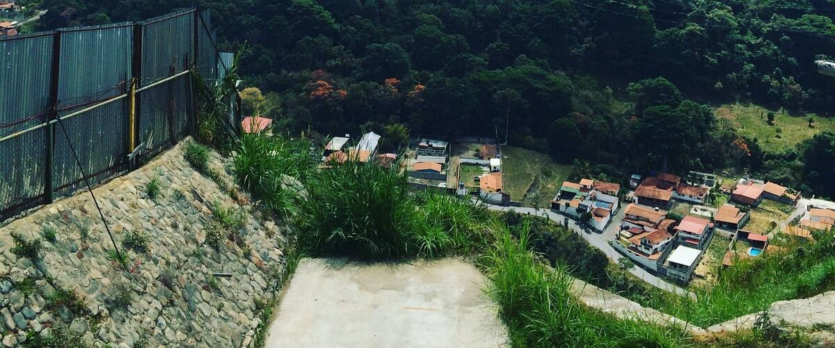 A mountainous landscape with a village at the base.