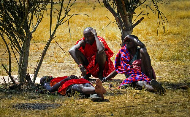 Some Maasai tribesmen relaxing and enjoying some shade during our visit to their village.  