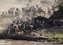 A herd of wildebeests crossing a riverbank.