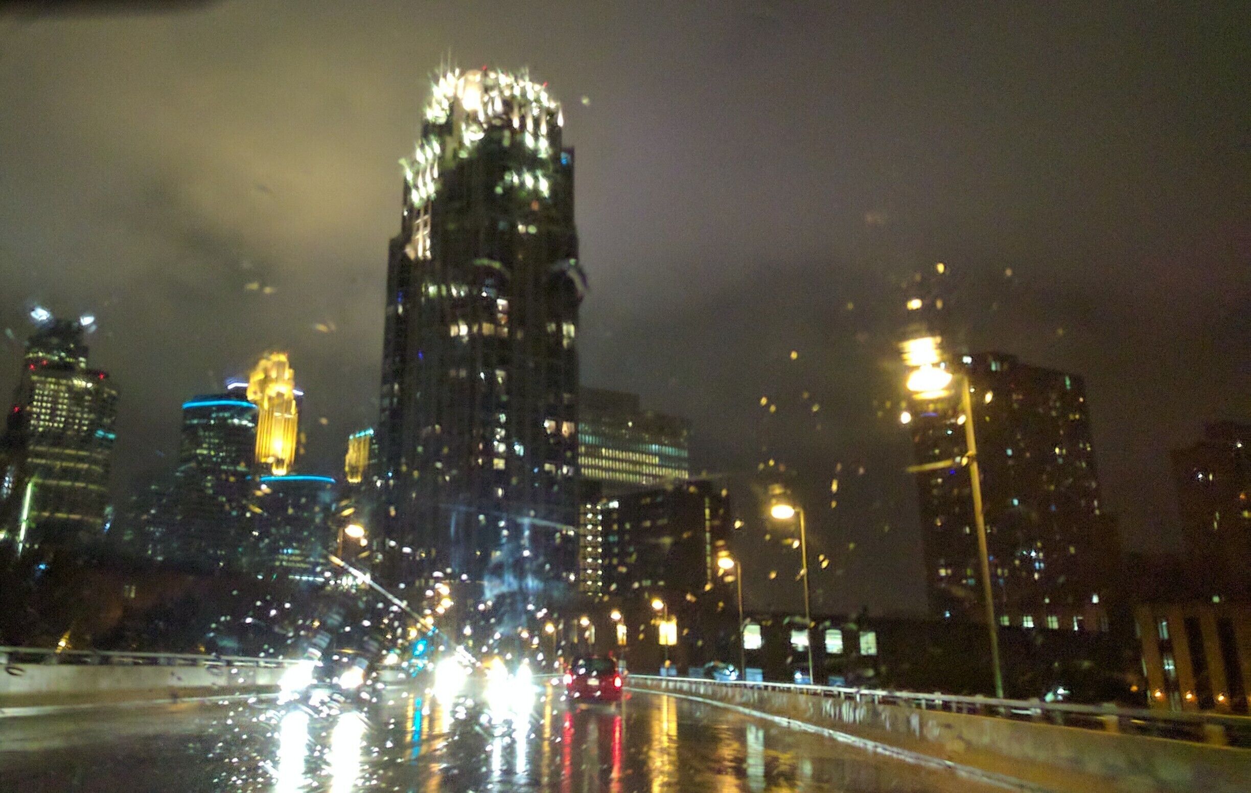 Yeah it's a total cliché but one I love. A surprisingly warm October night through a wet windshield. The hard part was missing the wipers 