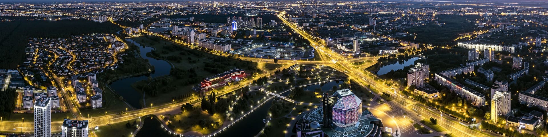 picturesque panoramic aerial view cityscape with bright street illumination. drone photo.