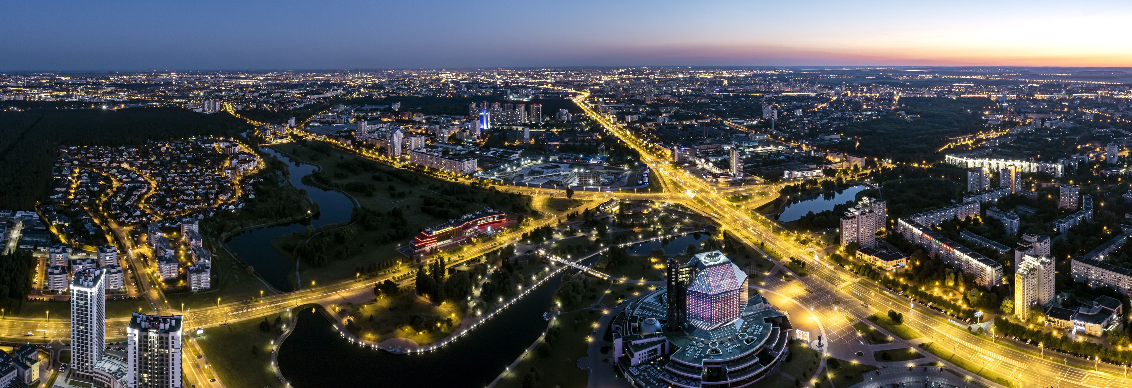 picturesque panoramic aerial view cityscape with bright street illumination. drone photo.