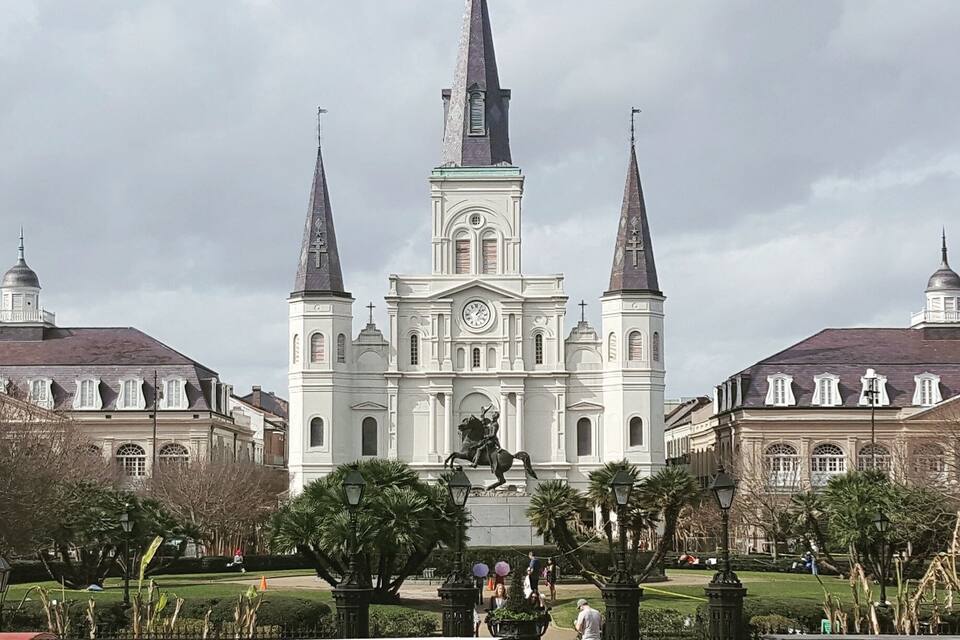 A large white church with two tall spires and a central clock tower.