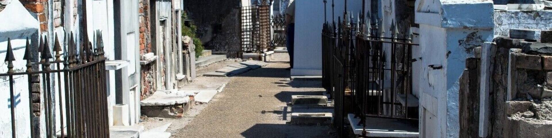 A cemetery with headstones and a building in the background.
