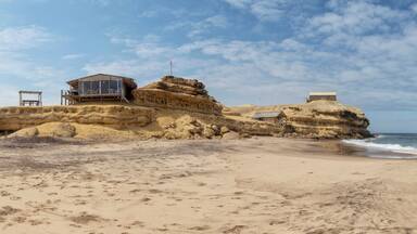Canyon on Namibe Desert Beach. With wooden houses and porch. Africa. Angola.