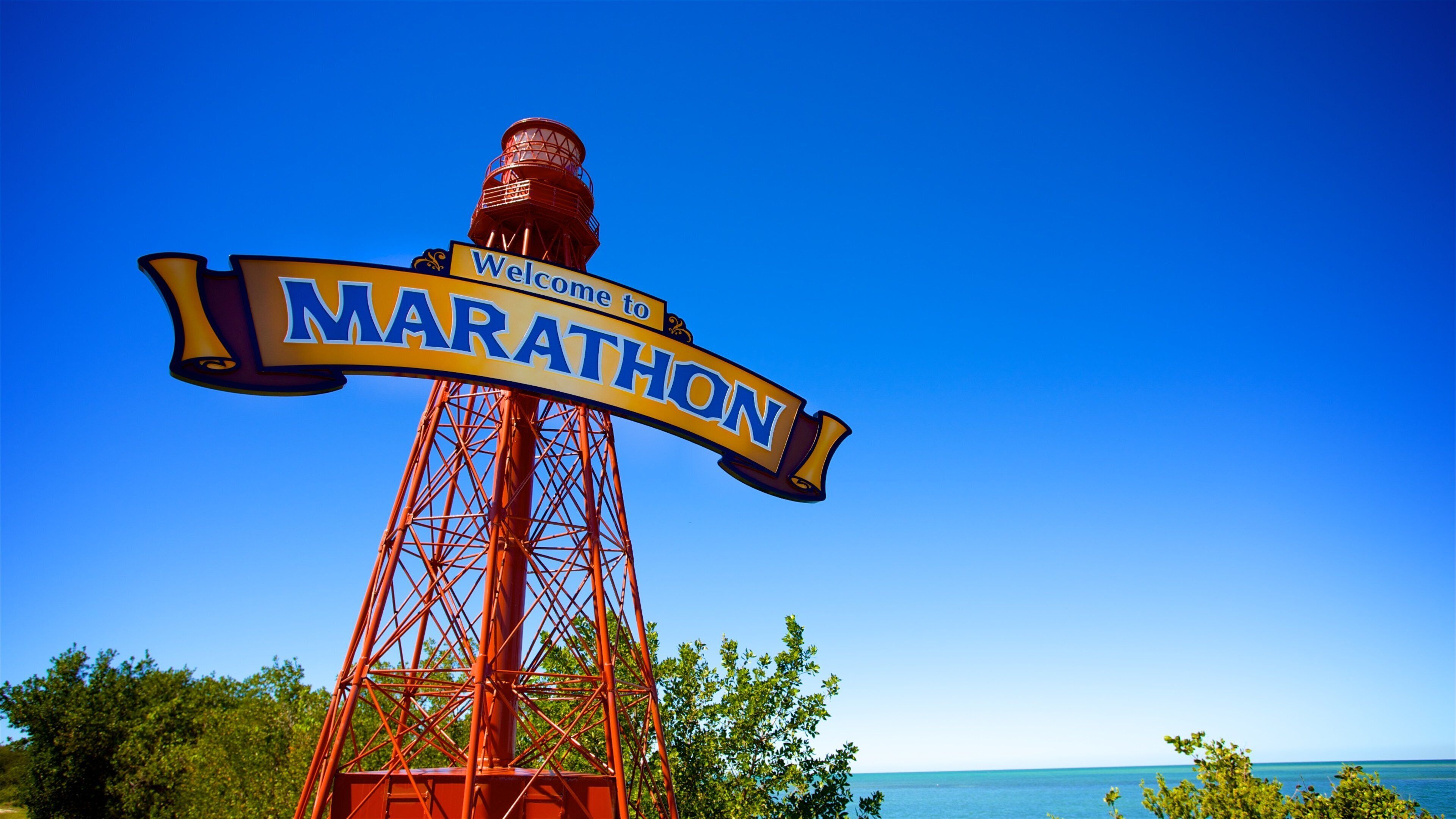 A tall red metal structure with a 'Welcome to Marathon' sign.