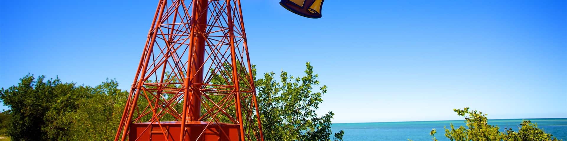 A tall red metal structure with a 'Welcome to Marathon' sign.
