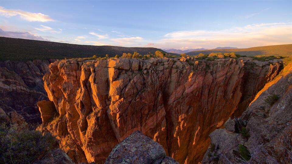 A canyon with steep cliffs and sparse vegetation.
