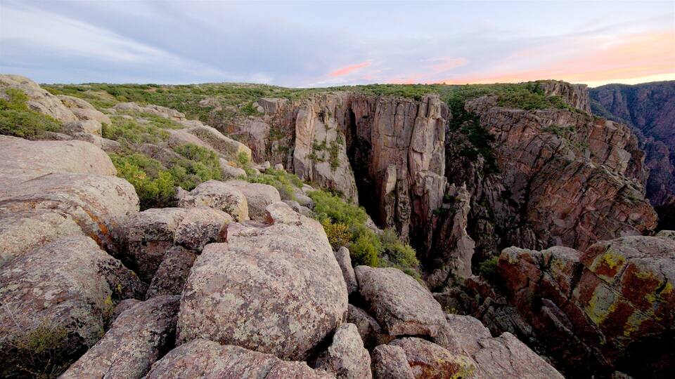 A rocky canyon with large boulders and steep cliffs.