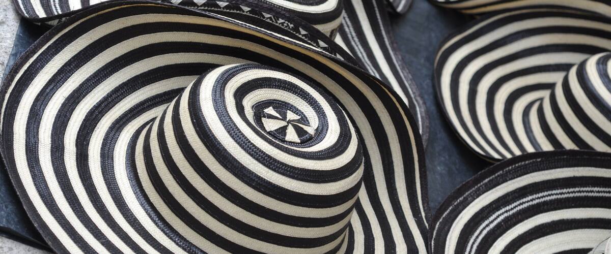A collection of black and white striped hats with a central design.