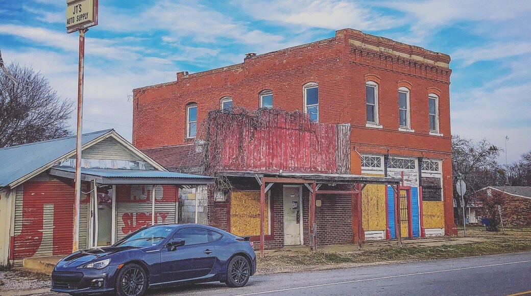 Old abandoned building next to shop