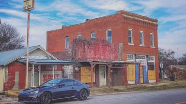 Old abandoned building next to shop