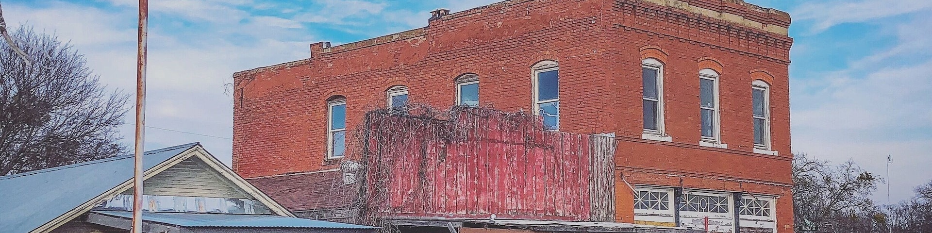 Old abandoned building next to shop
