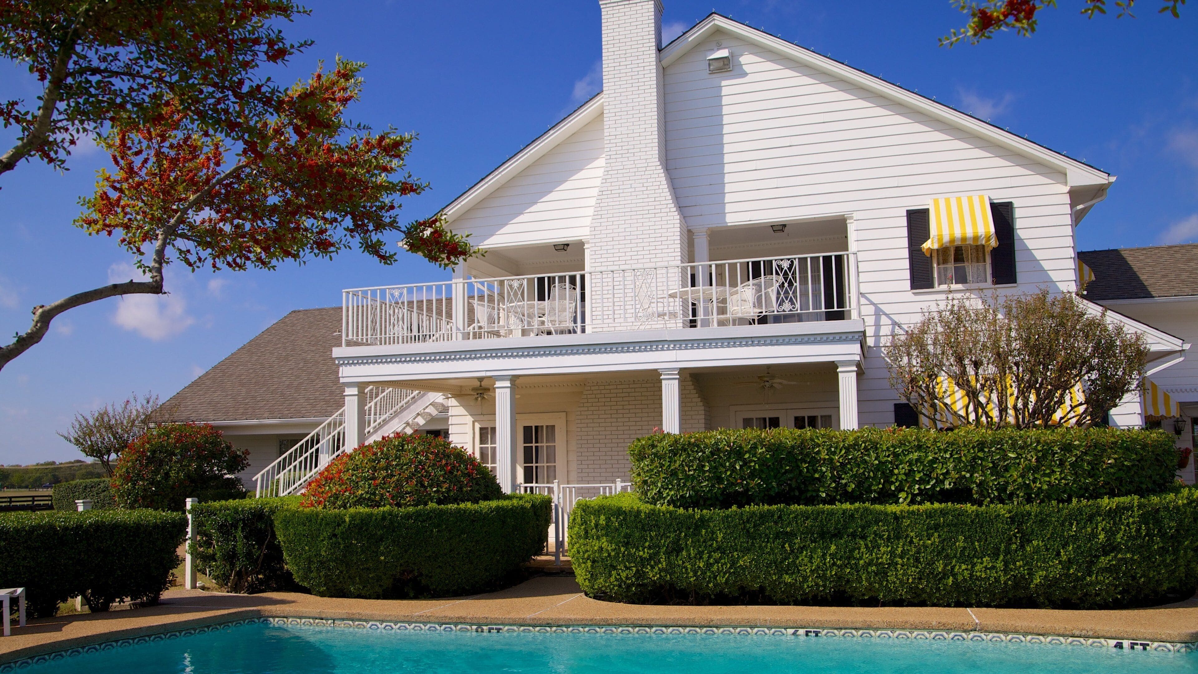 Southfork Ranch showing a pool and a house