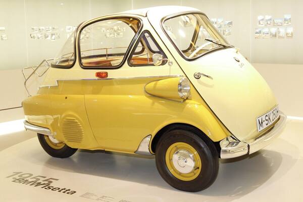 I'm not a "Gear-Head" by any means but... I do love German engineering and am specially fond of BMW, who now owns MINI Cooper.
This is the 1955 BMW Isetta (1955–62), also known as the "Bubble-Car". 161,728 units were made.
Although Italian designed it was licensed for manufacture in several different countries. If your looking to get a decent Isetta today expect to pay a bit north of $40,000.
I like it... It's just silly enough for me and I need to know how many clowns we can fit into one.
As far as the museum goes... a MUST do when visiting Munich, even if your not a gear-head.