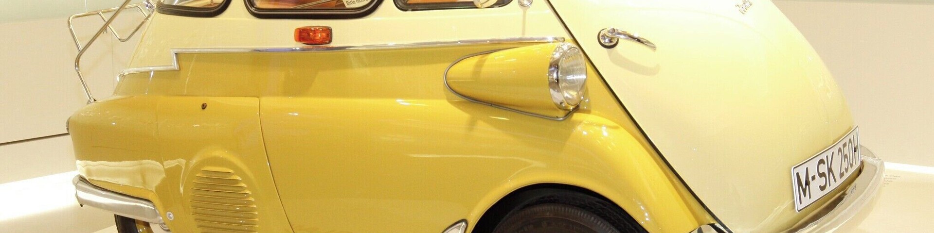 I'm not a "Gear-Head" by any means but... I do love German engineering and am specially fond of BMW, who now owns MINI Cooper.
This is the 1955 BMW Isetta (1955–62), also known as the "Bubble-Car". 161,728 units were made.
Although Italian designed it was licensed for manufacture in several different countries. If your looking to get a decent Isetta today expect to pay a bit north of $40,000.
I like it... It's just silly enough for me and I need to know how many clowns we can fit into one.
As far as the museum goes... a MUST do when visiting Munich, even if your not a gear-head.