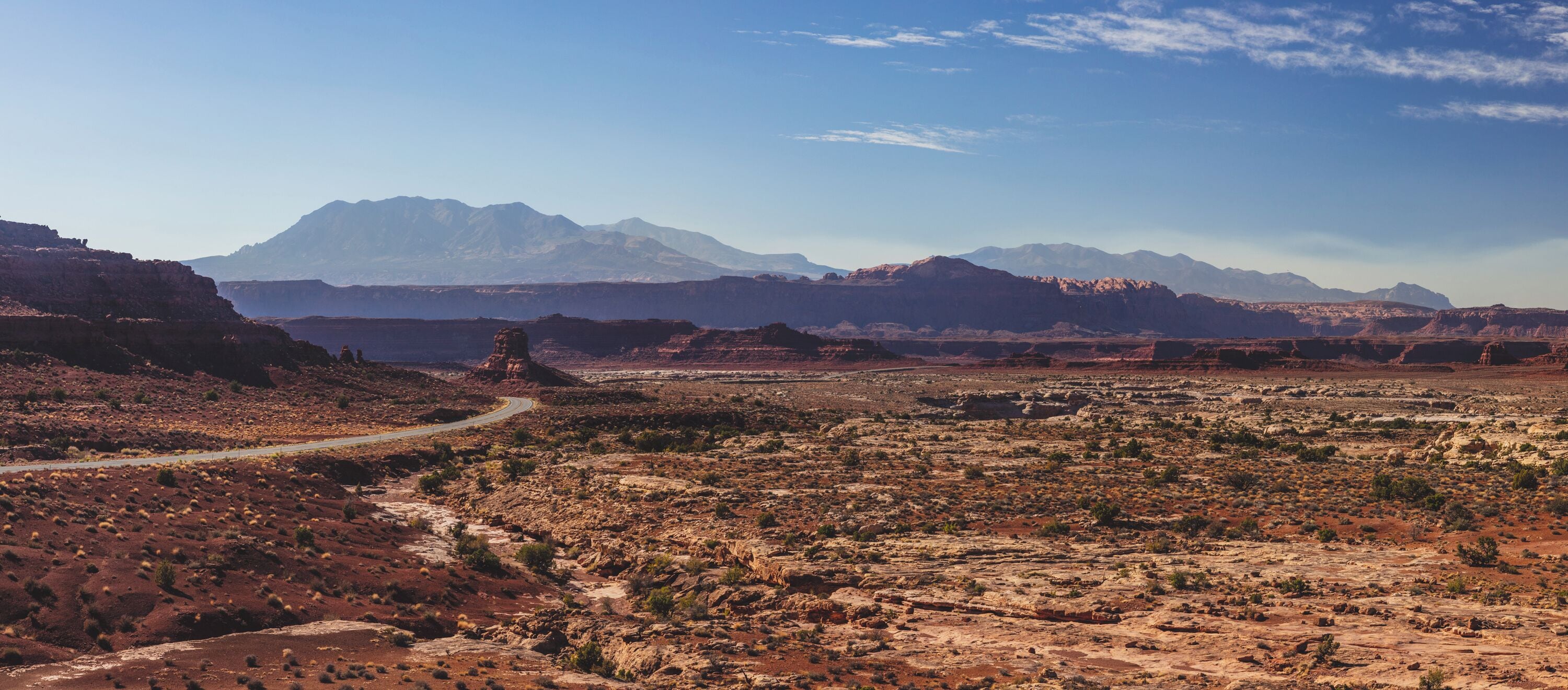 Normally I try to plan a general idea of what to do on a trip, but during the trip be up for spontaneity. After leaving Arches I decided to not go up to the expressway and back down to Goblin Valley State Park; instead I retraced part of my trip so I could stop by Arches National Monument and take HY-95. I am so very glad I did. It was by far the best stretch of road on my trip. I was stopping every few miles to get out and enjoy the view. From here I was able to get a complete 360 degree view of The sierra mountains and tributaries of Glenn Canyon. 

To give perspective; it was supposed to be a 4 hour drive that day. I started around 8 AM. I didn't get to Goblin Valley until 7 PM. This is a spectacular drive and one you should definitely plan to use as a way of connecting destinations on your trip. 