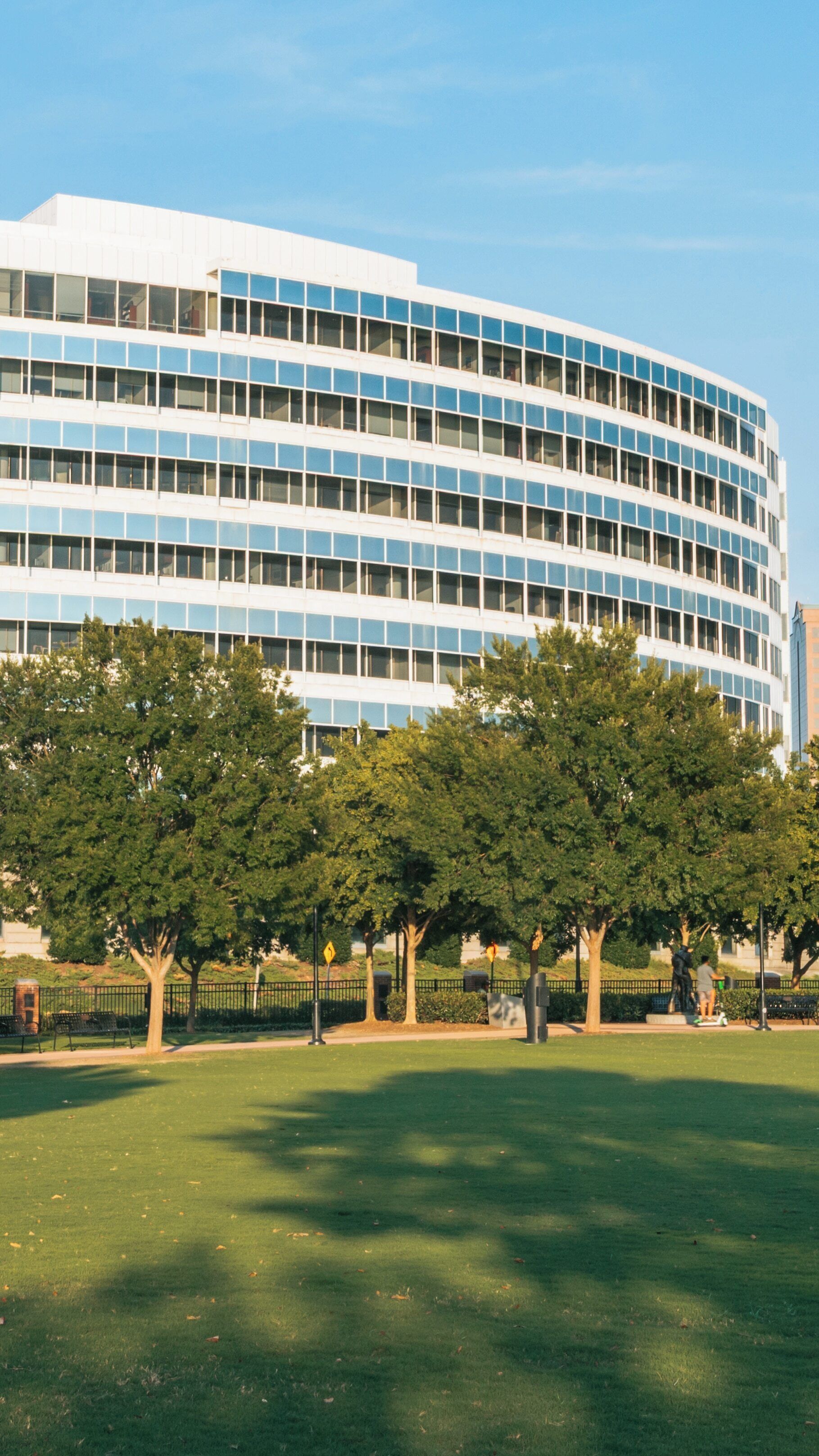 Town Point Park features lush greenery and modern architecture in downtown Norfolk, Virginia during a sunny day