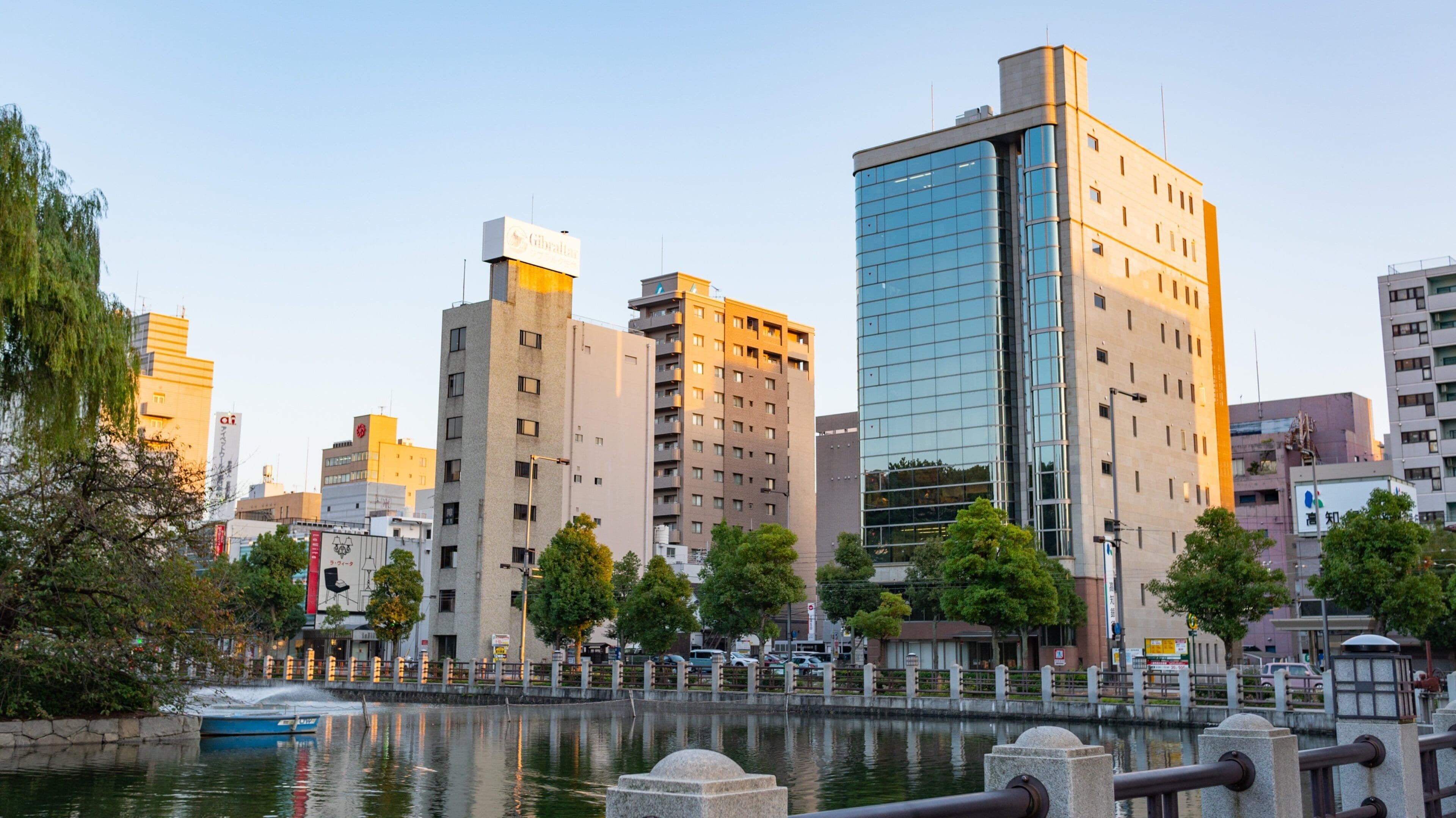 Matsuyama featuring a city, a sunset and a pond