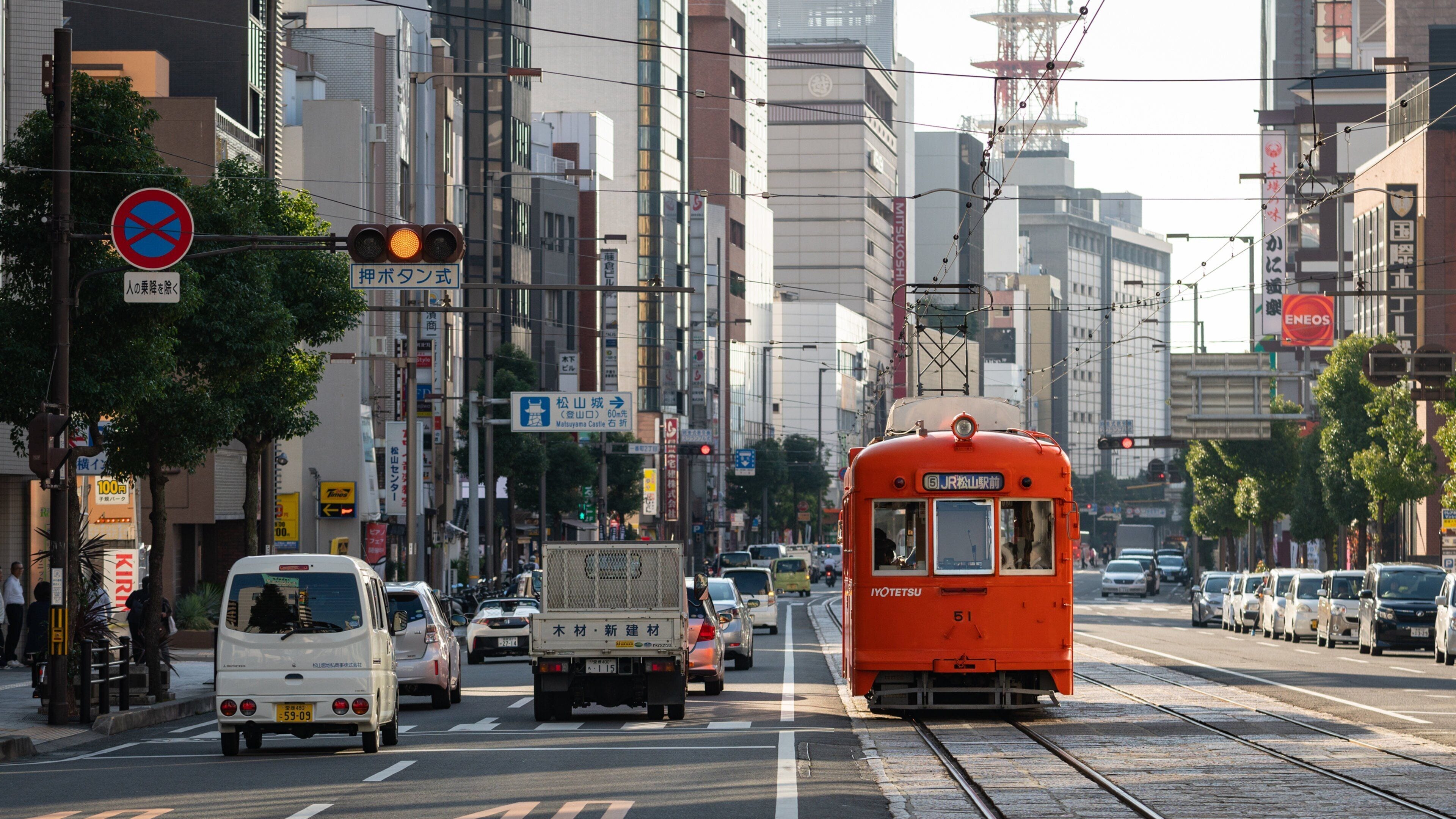Matsuyama featuring railway items, a city and street scenes