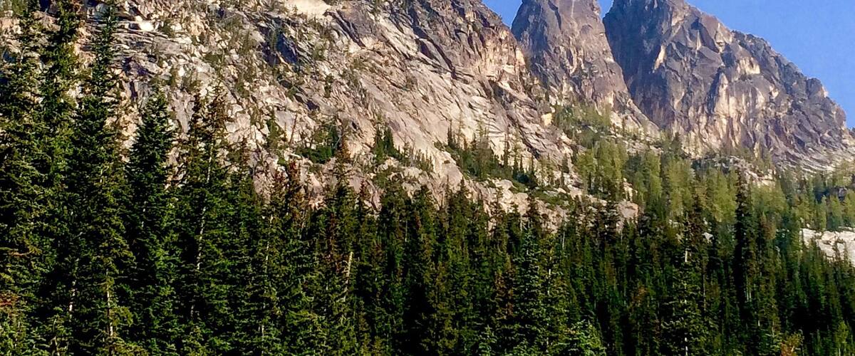 That's Liberty Bell peak on the left (7720 ft. /2353 m.) and the Early Winters Spires on the far right. The one in the middle is one of three mountains called the "towers," but since I can only see its balding little head, I won't hazard a guess as to which it is.
You don't have to be a mountain climber to get here. You just need to take the relatively short Blue Lake Trail, which runs for about two miles, and drops you off at one of the most beautiful alpine lakes you'll ever see. And since the lake pass tops off much earlier than these mountains (6254 ft. / 1906 m.), you'll have plenty of time to stop and gaze at the scenery.
Be forewarned, however: there is more than one Blue Lake in the state of Washington.
This is the one you want: http://www.wta.org/go-hiking/hikes/blue-lake
#snow