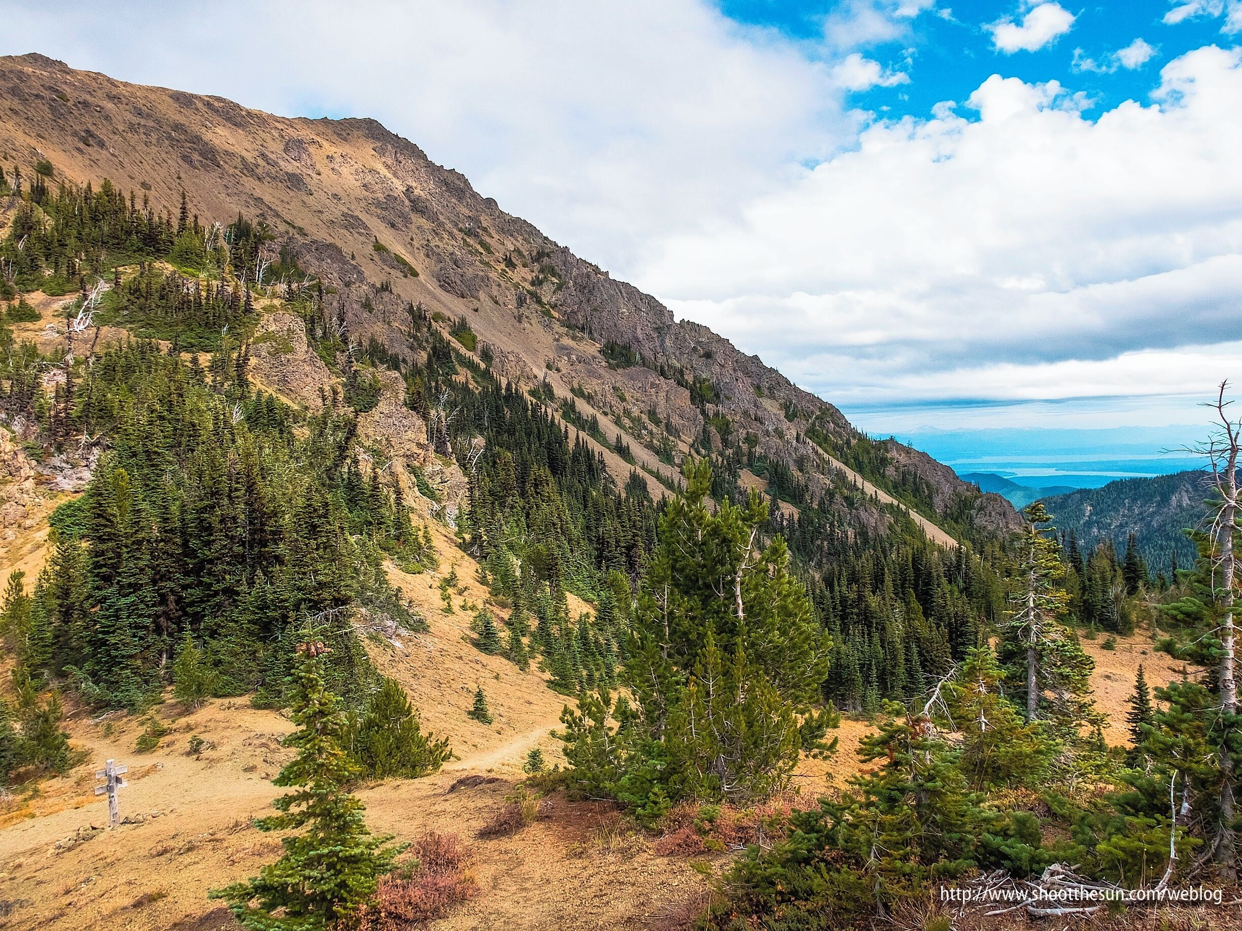 The sign I just showed you in the last discovery looks mighty puny there in the lower left-hand corner of this image.

The ridge behind it dominates the pass.
