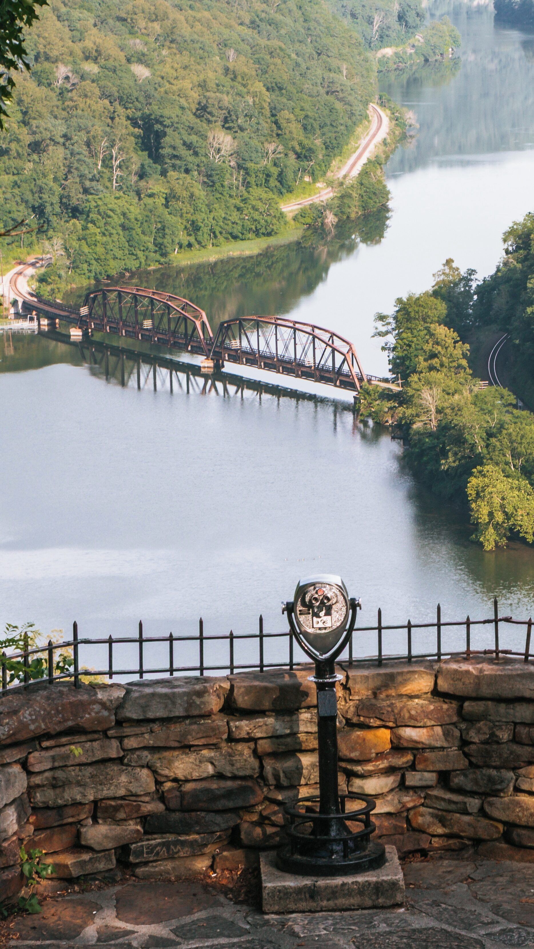 Viewpoint at Hawks Nest State Park offers stunning vistas of the New River and historic bridge in Ansted, West Virginia during a sunny day
