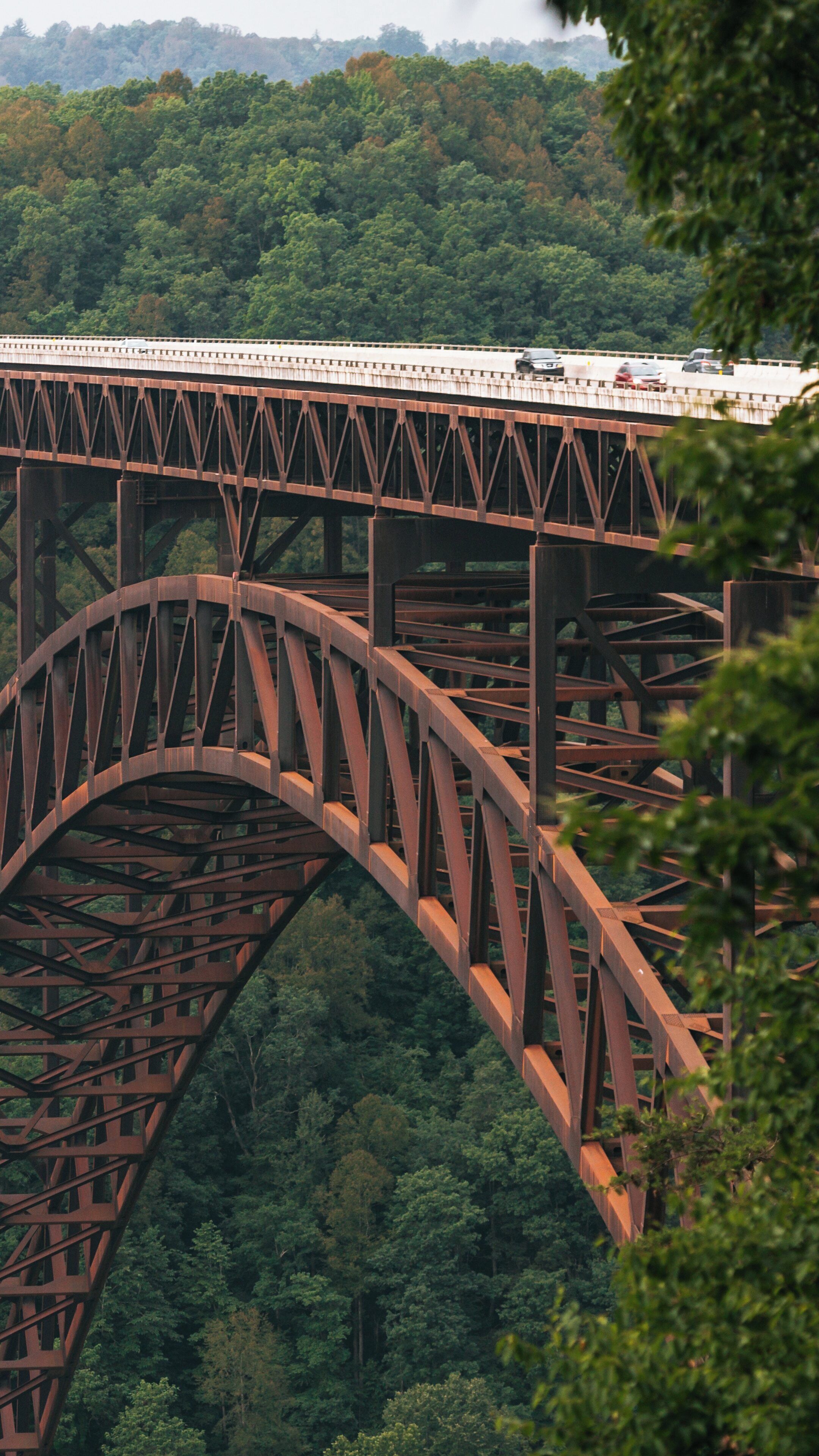 New River Gorge Bridge spanning lush landscapes in Fayetteville, West Virginia during a clear day, showcasing architectural marvel and natural beauty