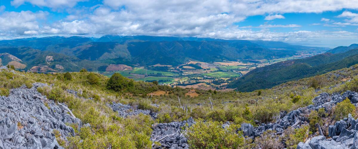 A mountainous landscape with rocky terrain and green valleys.