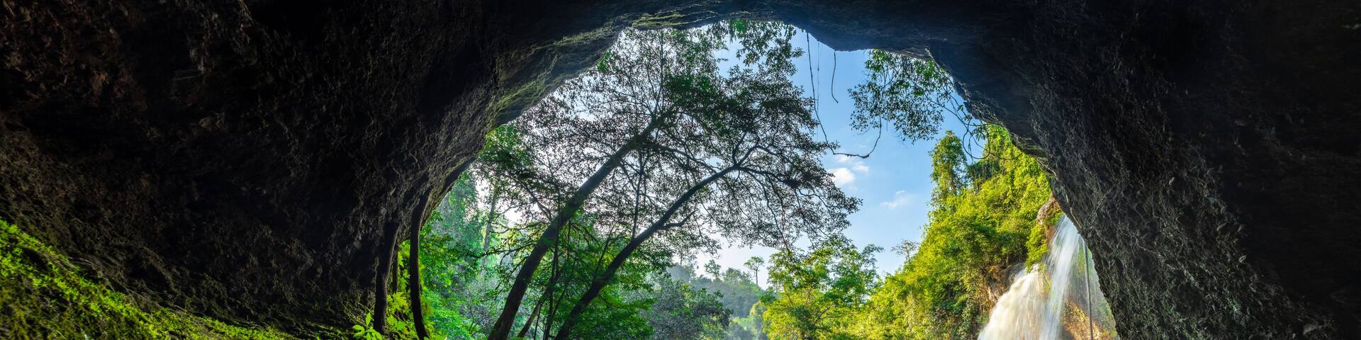 Haew Suwat Waterfall Khao Yai National Park, Nakhon Ratchasima, Thailand Waterfall view from the inside of the cave. Seeing is a beautiful rainbow