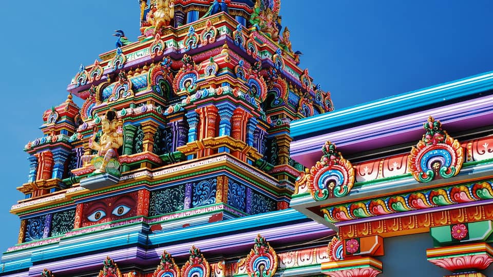 A colorful temple with intricate carvings and statues.