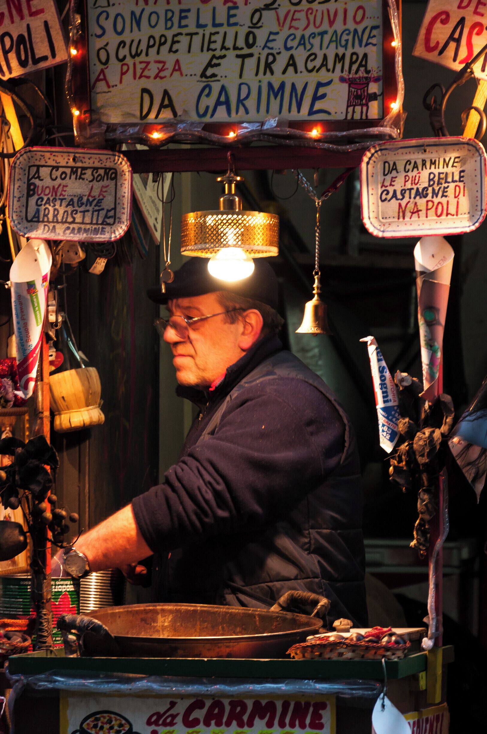 A man (Carmine) roasting chestnuts on the street

