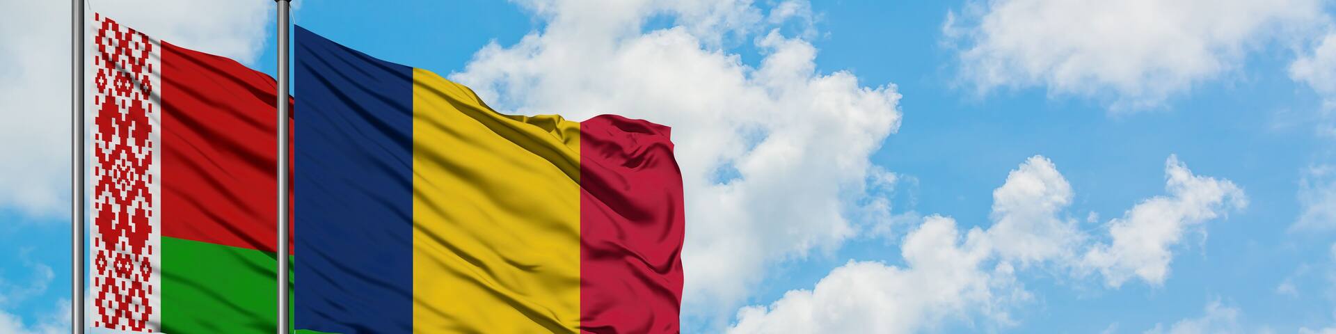 Belarus and Chad flag waving in the wind against white cloudy blue sky together. Diplomacy concept, international relations.