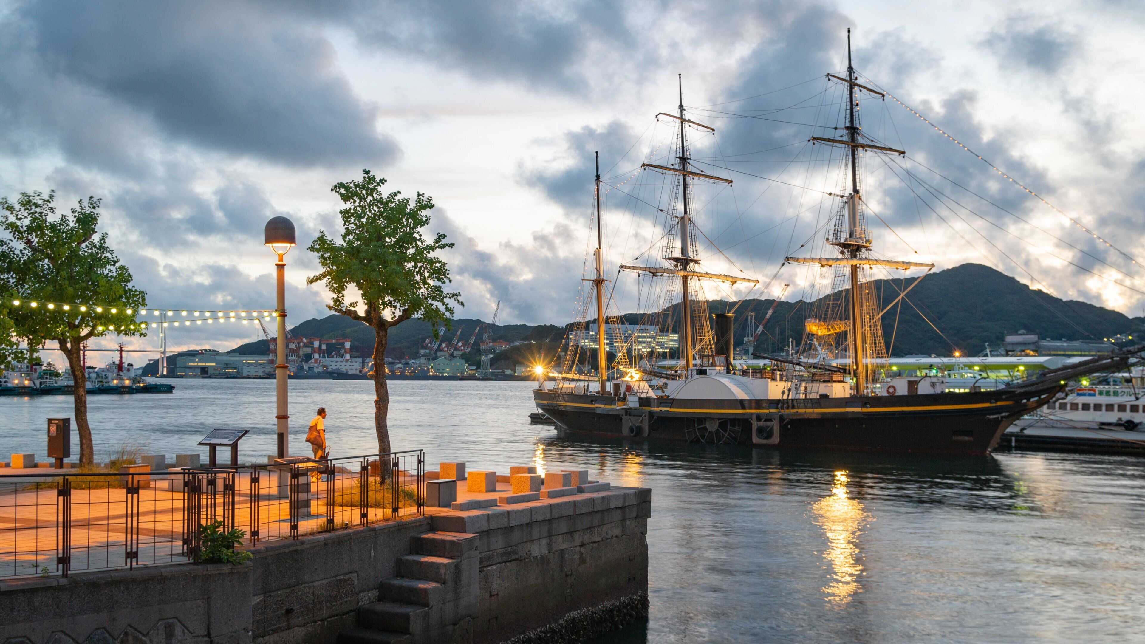 Nagasaki featuring a sunset, a bay or harbor and heritage elements