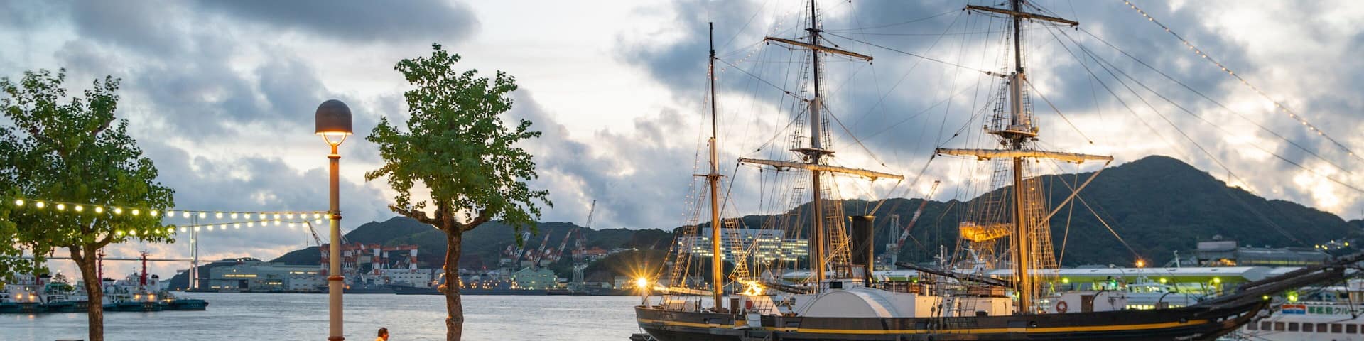 Nagasaki featuring a sunset, a bay or harbor and heritage elements