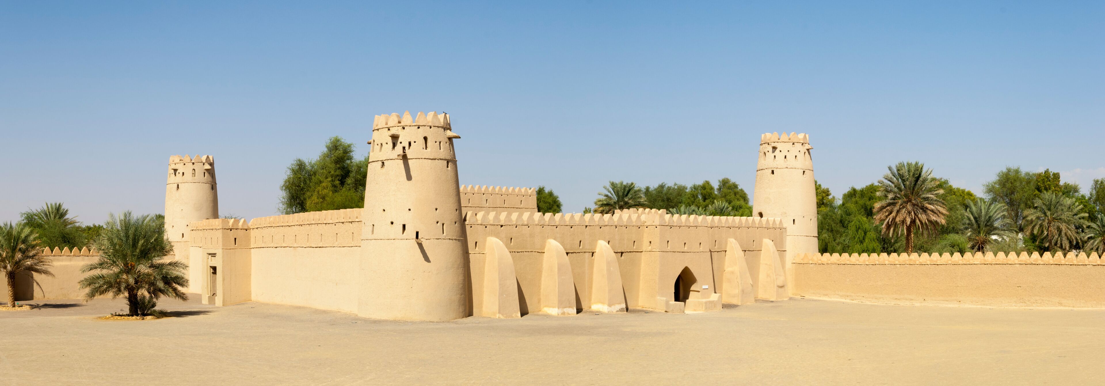 A large, beige fortress with multiple towers and a surrounding wall.