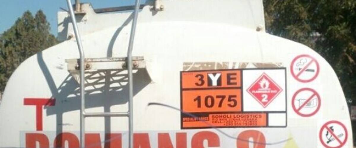 A white tanker truck with the text "ROMANS 8" and "3YE 1075" on it.
