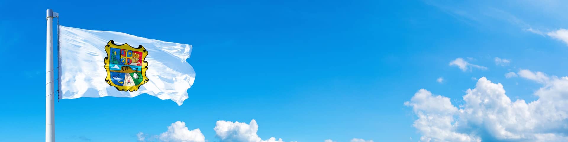 Tamaulipas, state of Mexico - flag waving on a blue sky in beautiful clouds - Horizontal banner