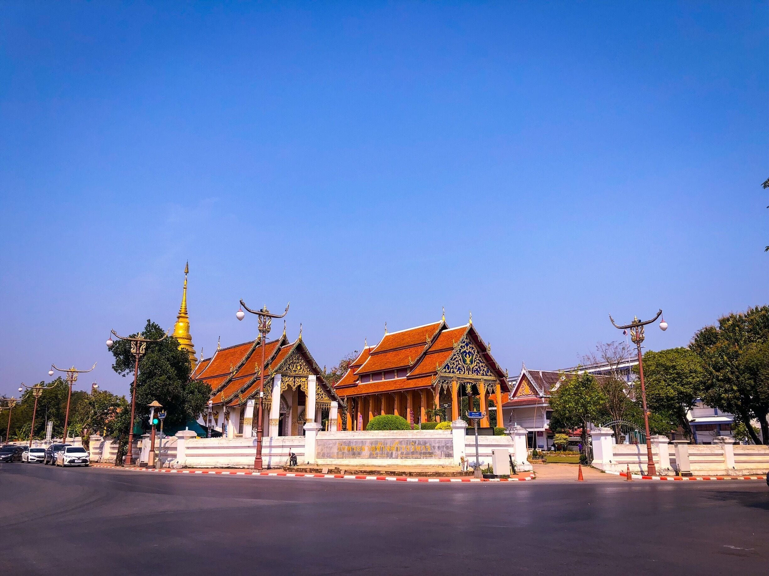 A traditional Thai temple with ornate architecture and a golden spire.