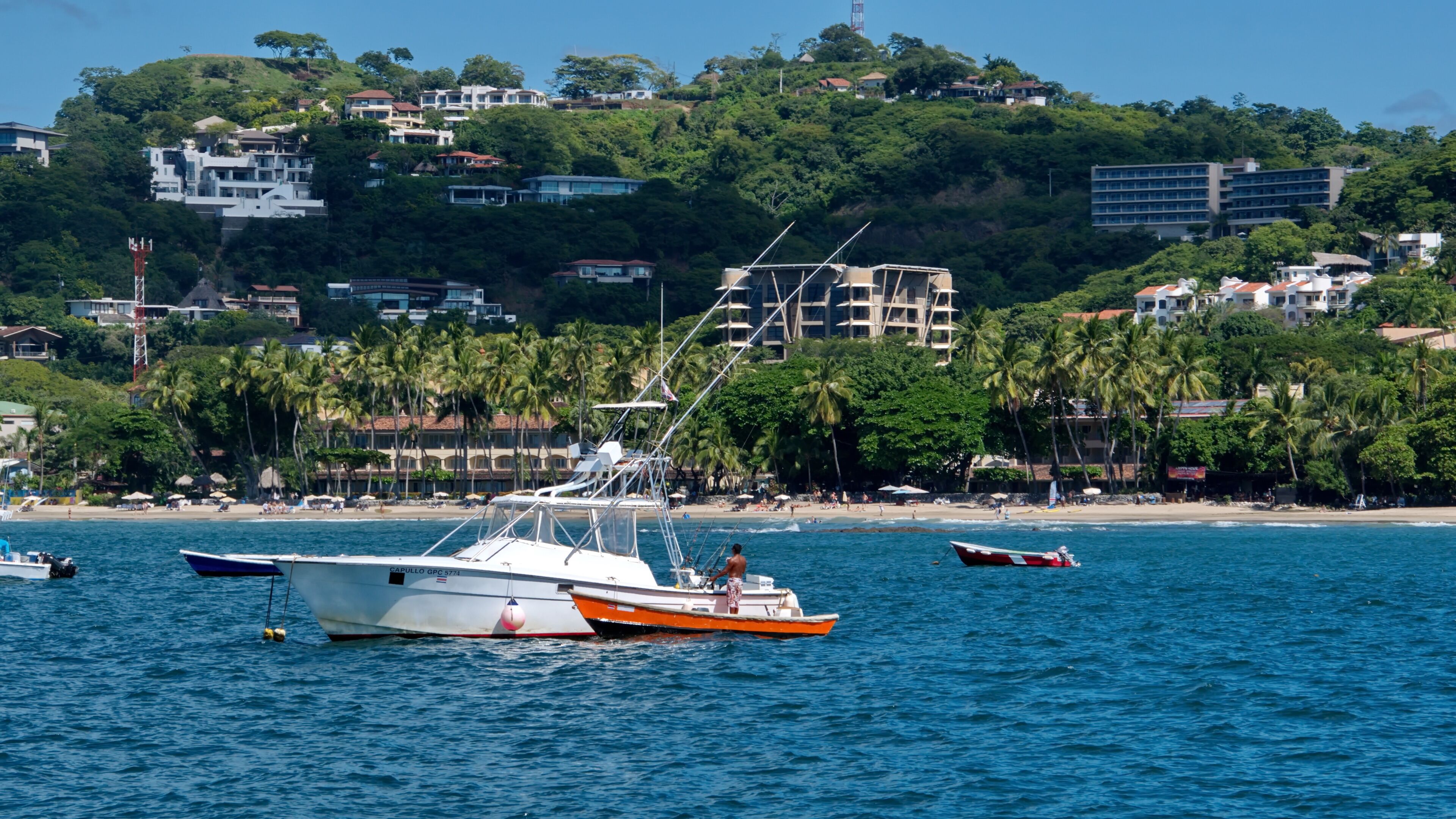 Boats moored in the bay off the beach in Tamarindo, Guanacaste, Costa Rica