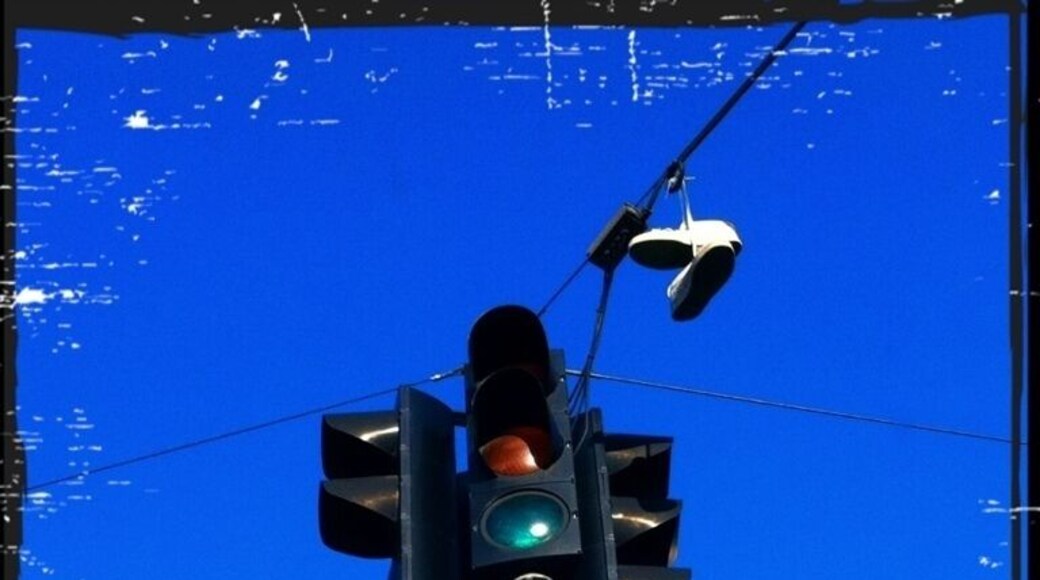 Somebody forgot their shoes next to the traffic signal...
