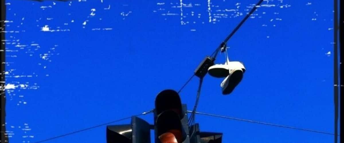 Somebody forgot their shoes next to the traffic signal...