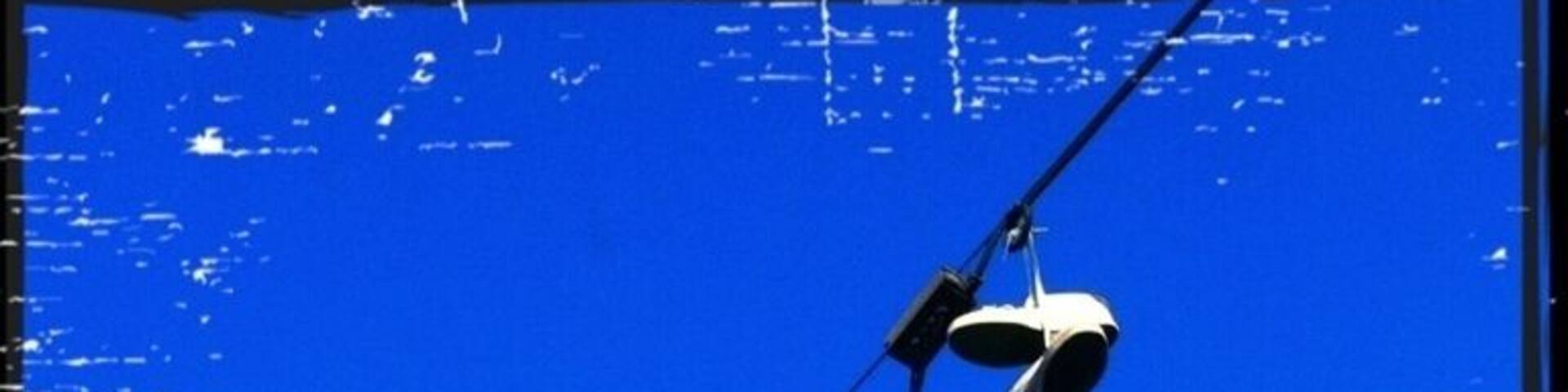 Somebody forgot their shoes next to the traffic signal...