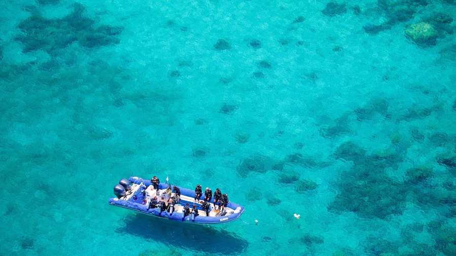 Noumea featuring boating and general coastal views as well as a small group of people