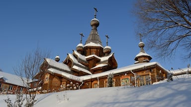 Wooden church in sunny winter day. Christian temple of the Holy Martyr John the Warrior in Novokuznetsk, Russia.