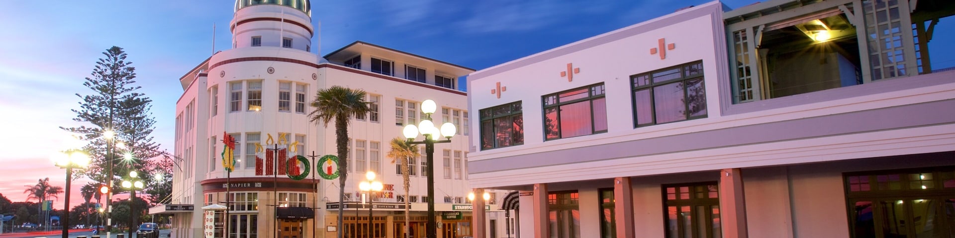 A historic building with a clock tower, a theater, and a Starbucks.