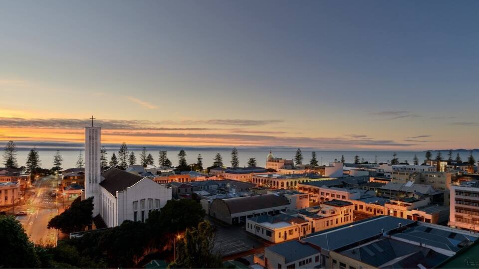 Dawn rises over the city of Napier, with St Paul's Cathedral to the left of shot