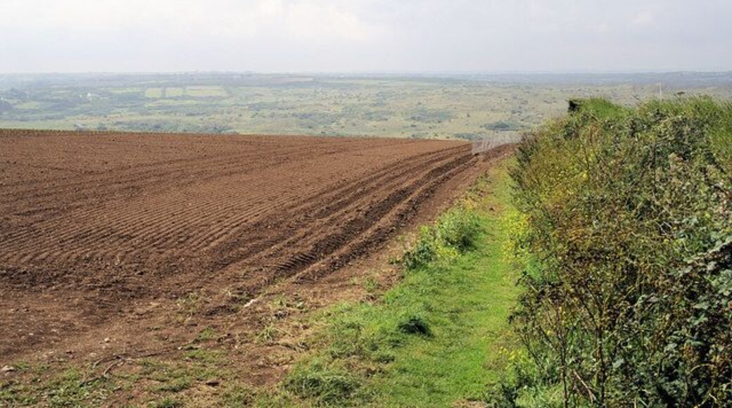 Footpath to Ellenglaze View southwards from the north end of the footpath to Ellenglaze. In the distance is a hazy view across the back of the dunes at Penhale Sands.
