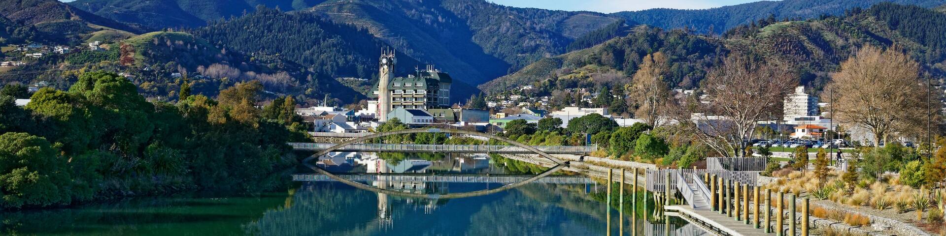 Panorama of Nelson City, reflected in the Maitai River, New Zealand.
